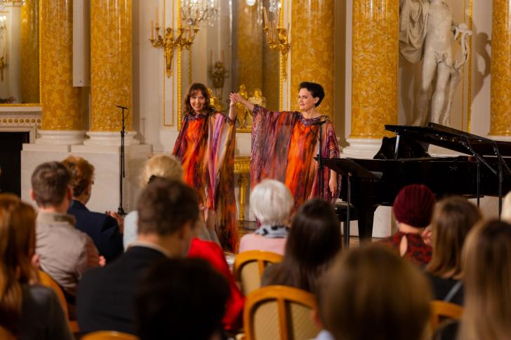 Olga Pasiecznik i Natalia Pasiecznik trzymają się za ręce i kłaniają sią w sali koncertowej na Zamku Królewskim
